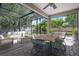 Screened patio featuring brick flooring, outdoor seating, and lush landscaping at 1719 Kenilworth St, Sarasota, FL 34231