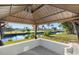 Canal view from gazebo featuring lush landscaping and peaceful waterfront at 221 Duxbury Ave, Port Charlotte, FL 33952