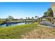 Backyard canal view with lush landscaping and a charming waterfront gazebo at 221 Duxbury Ave, Port Charlotte, FL 33952