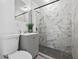 Updated bathroom featuring modern vanity and marble tiled shower with black accents at 221 Duxbury Ave, Port Charlotte, FL 33952