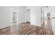 Spacious bedroom with wood-look floors and a doorway to an adjoining bathroom at 221 Duxbury Ave, Port Charlotte, FL 33952
