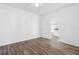 Bright bedroom featuring wood-look floors and an open doorway to the kitchen at 221 Duxbury Ave, Port Charlotte, FL 33952