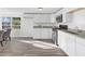 Modern kitchen with granite countertops, stainless steel appliances, and ample cabinet space for meal preparation and storage at 221 Duxbury Ave, Port Charlotte, FL 33952