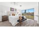 Bright main bedroom features a large window overlooking the backyard and modern decor at 221 Duxbury Ave, Port Charlotte, FL 33952