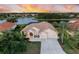 Waterfront home with tile roof, screened lanai and mature landscaping at sunset at 251 Dove Trl, Bradenton, FL 34212