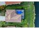 Aerial view of home with pool, screen lanai and lush landscaping at 251 Dove Trl, Bradenton, FL 34212
