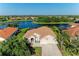 Gorgeous waterfront home with a tile roof, screened lanai and lush, mature landscaping at 251 Dove Trl, Bradenton, FL 34212