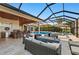 Screened-in patio with full outdoor kitchen, outdoor seating, a pool, and a scenic lake view at 251 Dove Trl, Bradenton, FL 34212