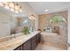 Spacious bathroom with marble countertop, soaking tub, and walk-in shower at 251 Dove Trl, Bradenton, FL 34212