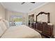 Bedroom with hardwood floors and sliding doors with views of the screened-in pool at 251 Dove Trl, Bradenton, FL 34212