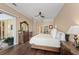 Bedroom with hardwood floors and sliding doors with views of the screened-in pool at 251 Dove Trl, Bradenton, FL 34212