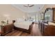 Spacious bedroom with hardwood floors and a view of the screened-in pool at 251 Dove Trl, Bradenton, FL 34212