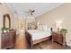 Spacious bedroom with hardwood floors, ceiling fan, and ensuite bathroom at 251 Dove Trl, Bradenton, FL 34212