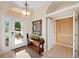 Inviting foyer with tile flooring, natural light, and a decorative console table at 251 Dove Trl, Bradenton, FL 34212
