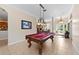Spacious game room featuring a pool table, chandelier, and elegant decor at 251 Dove Trl, Bradenton, FL 34212
