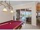 This game room features a pool table and an outdoor pool view at 251 Dove Trl, Bradenton, FL 34212