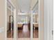 Hallway with entry to two bedrooms with ceiling fans and hardwood floors at 251 Dove Trl, Bradenton, FL 34212