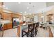 The kitchen features granite counters, stainless appliances, a breakfast bar and bright view into game room at 251 Dove Trl, Bradenton, FL 34212