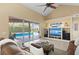 Comfortable living room featuring large windows with pool views and entertainment center at 251 Dove Trl, Bradenton, FL 34212