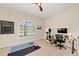 Home office with vaulted ceilings, lots of sunlight, work space, and exercise area at 251 Dove Trl, Bradenton, FL 34212