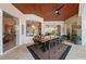 Covered outdoor dining area featuring tile flooring, ceiling fan, and table with seating for eight at 251 Dove Trl, Bradenton, FL 34212