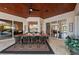 Elegant outdoor dining area featuring a wood ceiling, ceiling fan, and seating for eight, perfect for entertaining at 251 Dove Trl, Bradenton, FL 34212