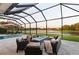 Screened patio with fire pit and comfortable seating overlooking lake at 251 Dove Trl, Bradenton, FL 34212