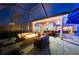 Relaxing outdoor living space with a fireplace, comfortable seating, and a fully equipped bar area for entertaining at 251 Dove Trl, Bradenton, FL 34212