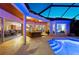 Expansive screened-in pool area with travertine tile, outdoor dining, and seamless access to the home's interior at 251 Dove Trl, Bradenton, FL 34212