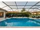 Inviting pool and spa inside screened lanai with lush landscaping at 251 Dove Trl, Bradenton, FL 34212