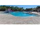 Beautiful community pool with water features, slide, and mushroom fountain on a sunny day at 251 Dove Trl, Bradenton, FL 34212