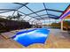 Screened pool with spa, lush landscaping, and ample seating provides a private and relaxing outdoor oasis at 251 Dove Trl, Bradenton, FL 34212