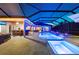 Inviting screened pool and hot tub with outdoor bar, TV, and ample seating areas perfect for entertaining at 251 Dove Trl, Bradenton, FL 34212