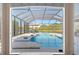 View of the screened-in pool and patio area from inside the house at 251 Dove Trl, Bradenton, FL 34212