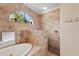 Shower and soaking tub with marble and views of the backyard at 251 Dove Trl, Bradenton, FL 34212