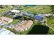 Aerial view of condo buildings, tennis courts, a clubhouse, and a well-manicured golf course with ponds at 2608 Waterford Way # B, Palmetto, FL 34221
