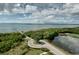 Aerial view of a waterfront community, showcasing the road, pier, and lush green landscaping at 2608 Waterford Way # B, Palmetto, FL 34221