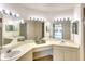 Bright bathroom featuring double sinks, vanity with lighting, and mirrors that enhance the space at 2608 Waterford Way # B, Palmetto, FL 34221