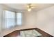 Cozy bedroom with a ceiling fan, large window with natural light, and hardwood flooring at 2608 Waterford Way # B, Palmetto, FL 34221