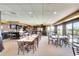 Large dining area with brick accent walls, many tables and chairs, and sunny windows at 2608 Waterford Way # B, Palmetto, FL 34221
