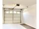Spacious garage with white walls, door with upper windows and concrete floor at 2608 Waterford Way # B, Palmetto, FL 34221