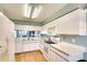 Bright kitchen with white cabinets, open view of the living room, and modern appliances at 2608 Waterford Way # B, Palmetto, FL 34221