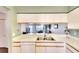 Open kitchen with a double sink and a view of the living room at 2608 Waterford Way # B, Palmetto, FL 34221