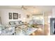 Open-concept living room featuring wood floors, neutral decor, and seamless flow into the dining and kitchen areas at 2608 Waterford Way # B, Palmetto, FL 34221