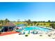 Community pool featuring a swim-up bar, lounge chairs, and views of the adjacent golf course and blue sky at 2608 Waterford Way # B, Palmetto, FL 34221