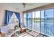 Inviting sunroom features large windows with lovely water views, comfortable seating, and a ceiling fan at 2608 Waterford Way # B, Palmetto, FL 34221