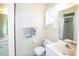 Bathroom with a window and shower with glass door at 2614 67Th W St, Bradenton, FL 34209