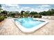 Beautiful community pool surrounded by well-maintained brick patio, lounge chairs, and lush landscaping at 2614 67Th W St, Bradenton, FL 34209