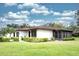 A single-story home featuring a cozy screened-in lanai, a well-maintained yard, and lush landscaping at 2614 67Th W St, Bradenton, FL 34209