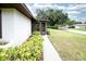 The side exterior of a cozy single-story home featuring a screened-in lanai with a well-kept yard at 2614 67Th W St, Bradenton, FL 34209